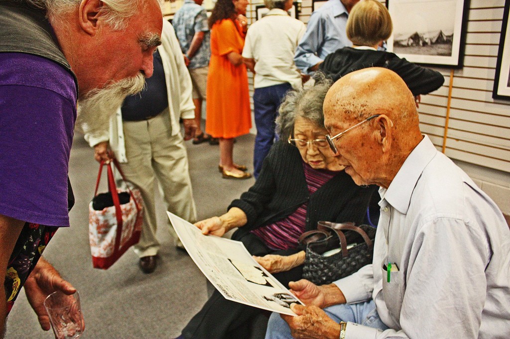 Oregon Cultural Heritage Commission president David Milholland discussed our Japanese translation of the exhibit's text panels with Ontario residents Tomie and Sagie Nishihara. Photo courtesy of Four Rivers Cultural Center. 