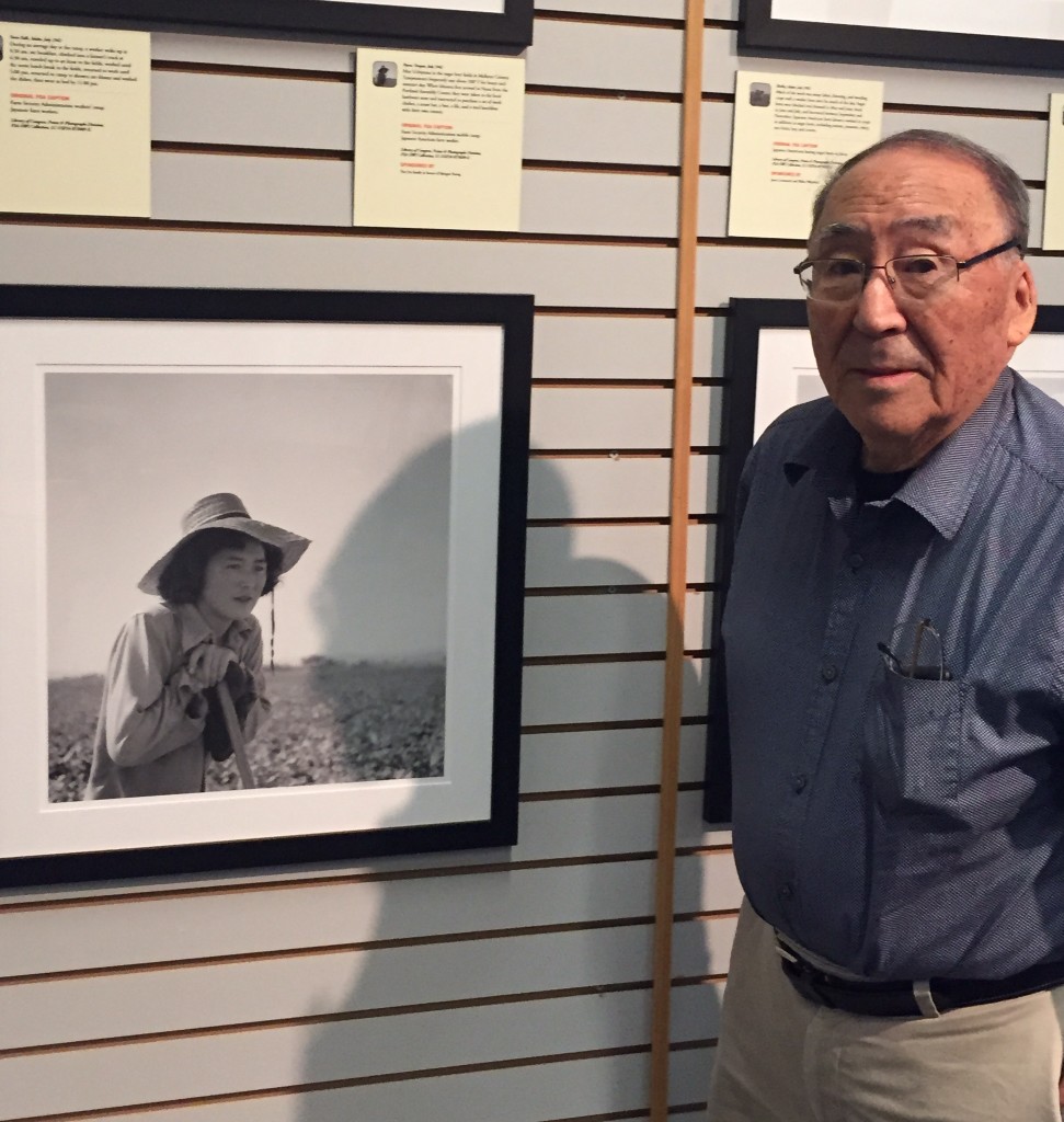 Mathias Uchiyama poses with a portrait of his sister May. Image courtesy of Susan Nagai. 